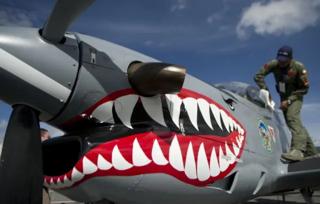 
          A member of the Colombian Air Force cleans a Super Tucano A-29B airplane during the F-Air Colombia 2013 Festival at Jose Maria Cordova airport in Rionegro, Antioquia department, on July 11, 2013.
        