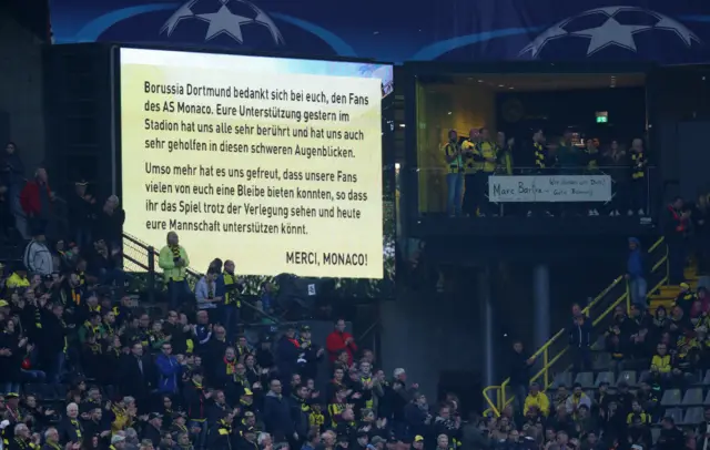 Borussia Dortmund display a message of thanks to Monaco fans before the match