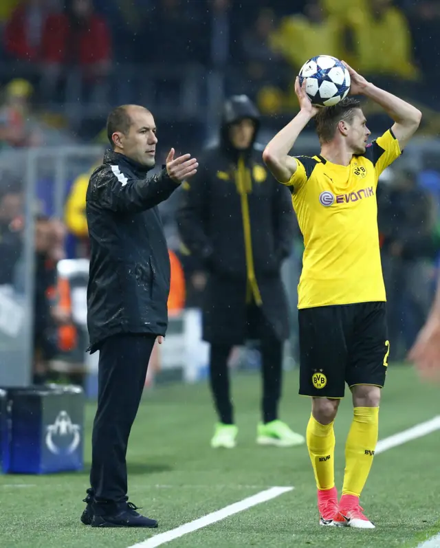 Borussia Dortmund"s Lukasz Piszczek prepares to take a throw in as Monaco coach Leonardo Jardim gestures