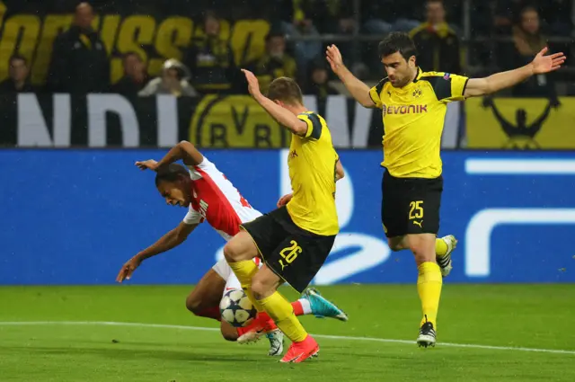 Borussia Dortmund"s Sokratis Papastathopoulos (R) fouls Monaco"s Kylian Mbappe-Lottin for a penalty