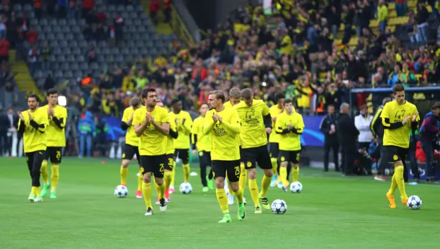 Borussia Dortmund players walk on to the pitch