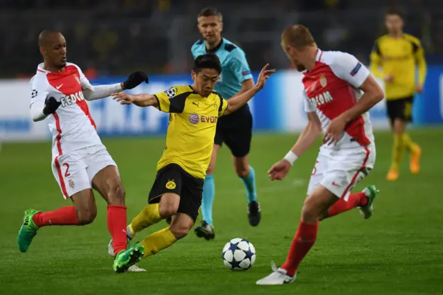 Shinji Kagawa is pressured Monaco's Brazilian Fabinho and Kamil Glik