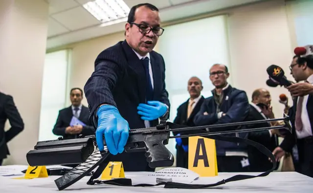 An official of the Central Bureau of Judicial Investigation (BCIJ) holds a confiscated submachine gun during a press conference in Sale, near the capital Rabat on January 29, 2017.