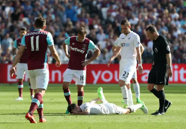 Jack Cork lies injured