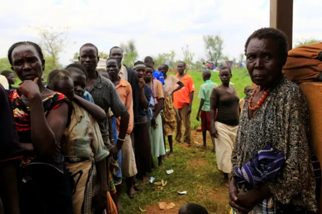 South Sudanese families displaced by fighting queue for vaccination in Lamwo after fleeing fighting in Pajok