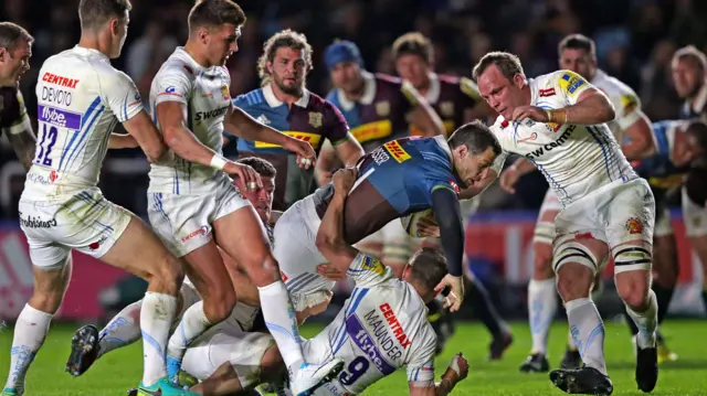 Tim Visser of Harlequins looks for space as he's tackled by Jack Maunder of Exeter(9)