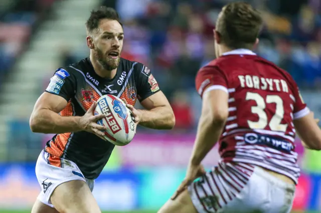 Luke Gale for Castleford takes on Liam Forsyth of Wigan