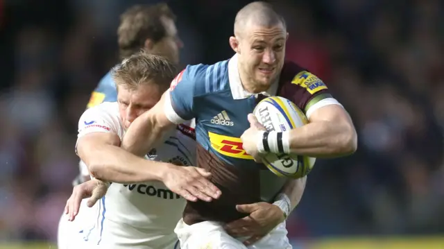 Mike Brown of Harlequins lokks to get away from Carl Rimmer of Exeter