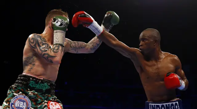 Julius Indongo reaches for Ricky Burns