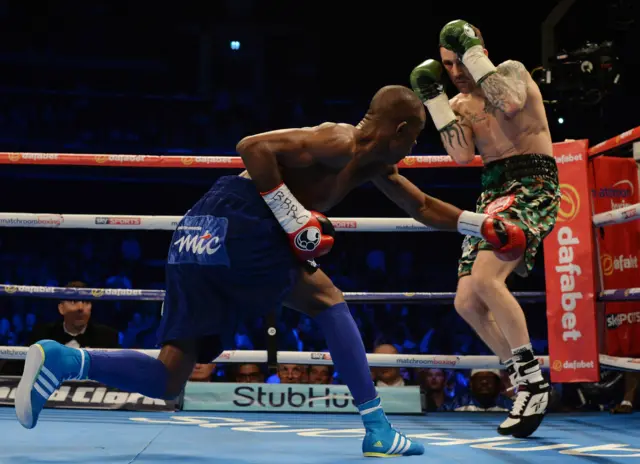 Ricky Burns is forced back by Julius Indongo