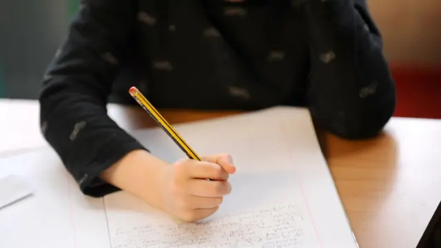 Child writing in school