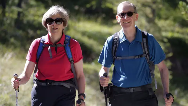 Prime Minister Theresa May walking in a forest with her husband Philip in 2016