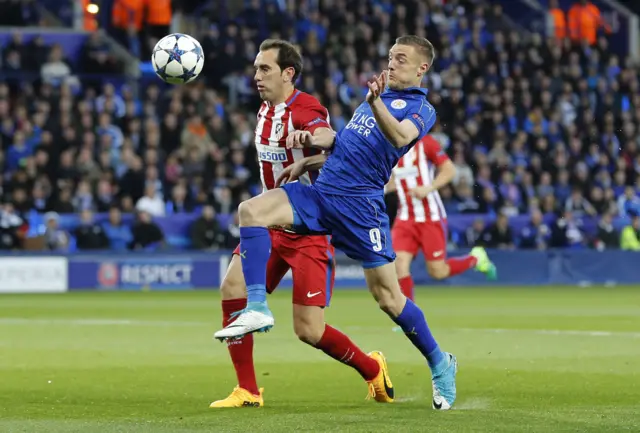 Jamie Vardy and Diego Godin challenge for the ball