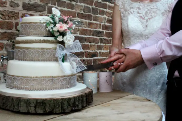 Bride and groom cutting cake