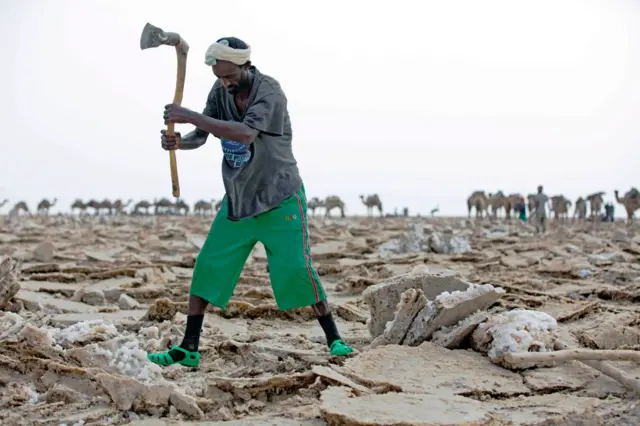 A man mines blocks of salt from the Danakil Depression on 28 March 2017, in Afar, Ethiopia