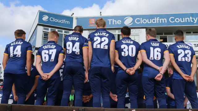 Essex players with their backs to the camera