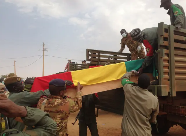 Caskets of slain Malian solders wrapped in the national flag