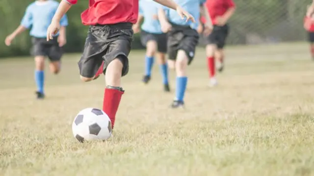 Youngsters playing football