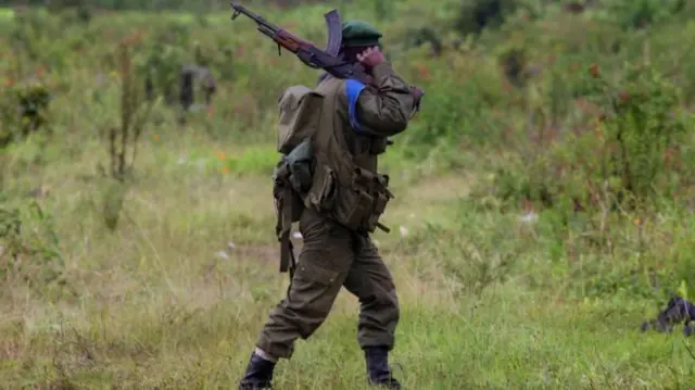 Congolese army soldier walks at the frontline, November 12, 2008 in the outskirts of the town of Goma,