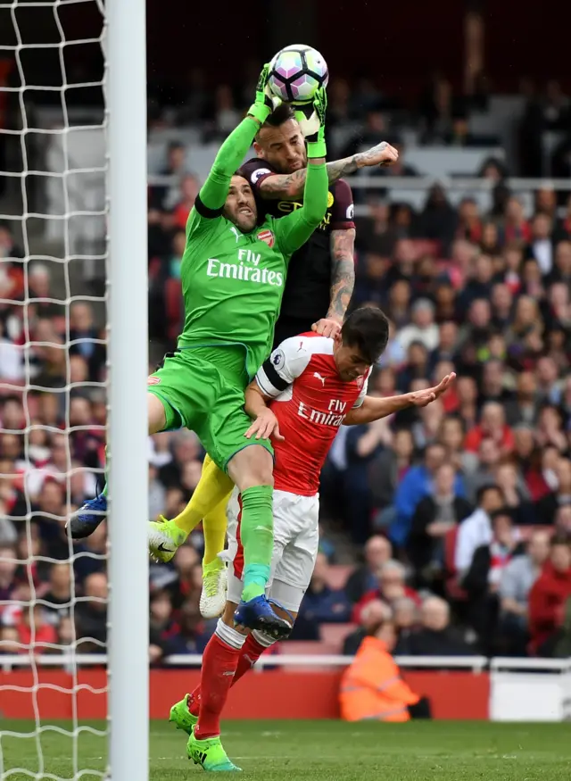 Ospina under a challenge from Nicolas Otamendi