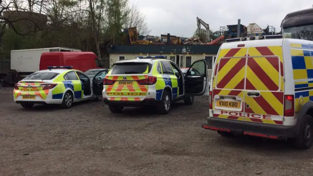 Police vehicles at scene of raid