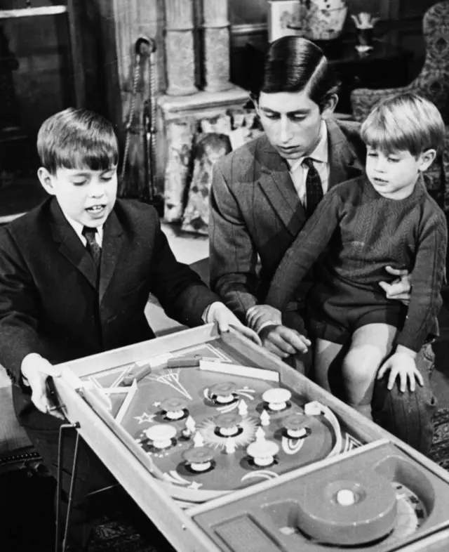 Prince Charles at Sandringham playing a game of Bagatelle with his two young brothers, Prince Andrew (left) and Prince Edward