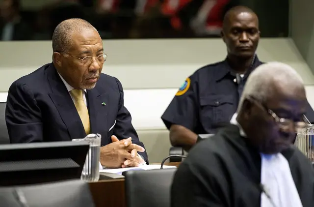 Former Liberian President Charles Taylor (L) waits on September 26, 2013 in the courtroom of the Special Court for Sierra Leone in The Hague before the start of his appeal judgement