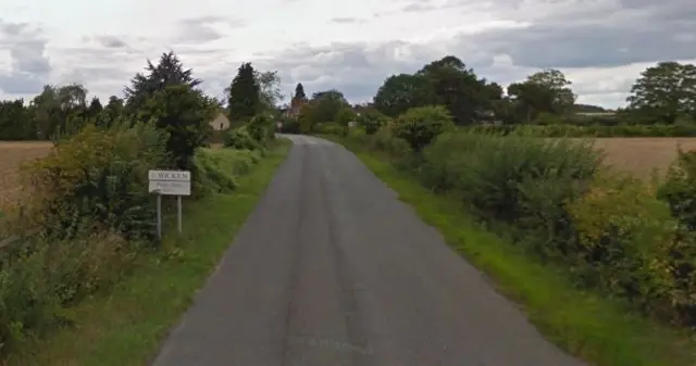 Deanshanger Road, Wicken with "Please Drive Slowly" sign