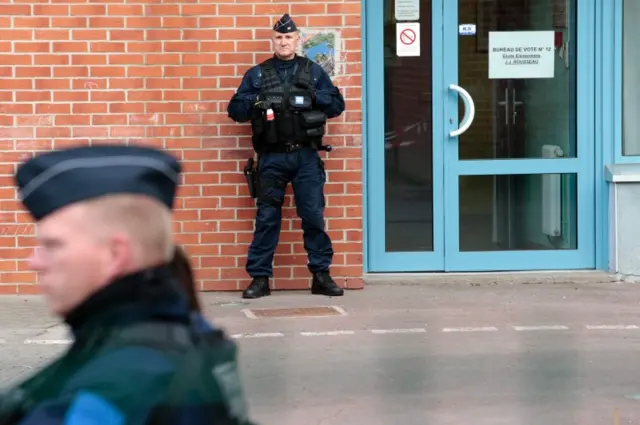 Police stand guard at polling station