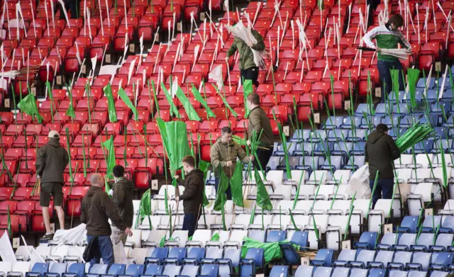 Celtic fans lay out flags at Hampden