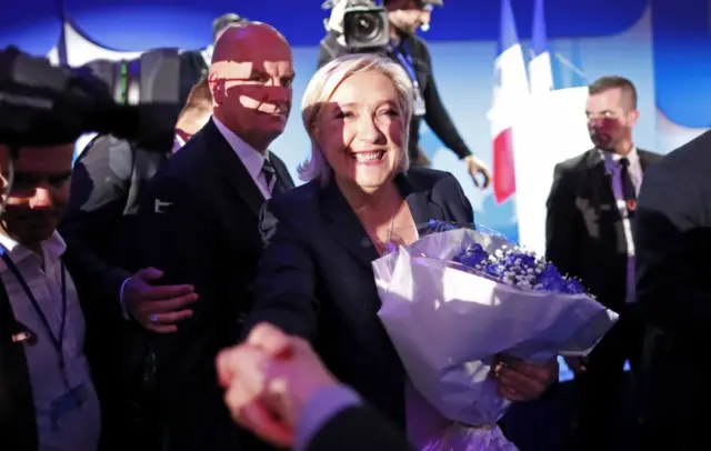 Marine Le Pen is greeted by supporters after making it to the second round of the French presidential elections, 23 April 2017