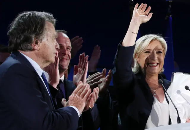 Marine Le Pen (R) waves to supporters after the results of the first round of the French presidential elections in Henin-Beaumont,