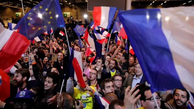 Supporters of Emmanuel Macron, head of the political movement En Marche!, celebrate, 23 April 2017