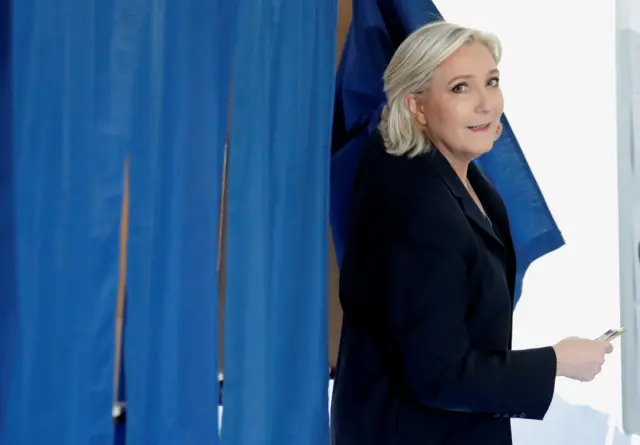 Marine Le Pen leaves a polling booth in Hénin-Beaumont