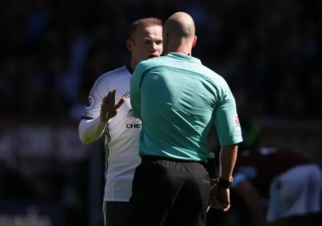 Wayne Rooney receives a yellow card