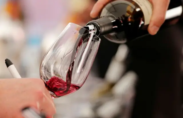 wine is poured into a glass