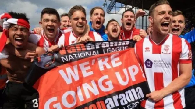 Lincoln City players celebrating promotion