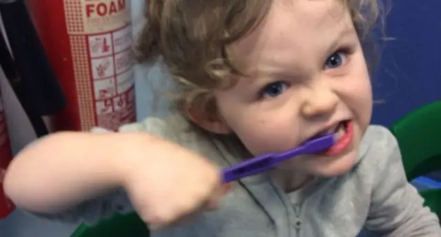 Child brushing her teeth