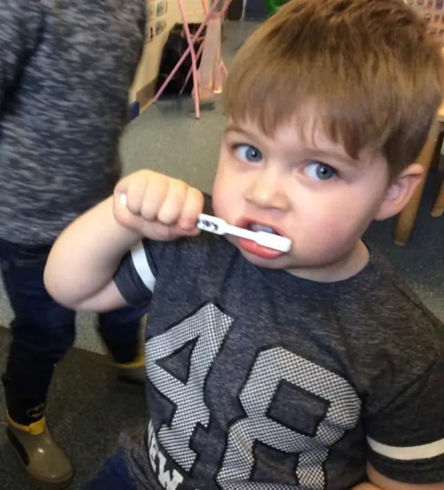 Child brushing teeth