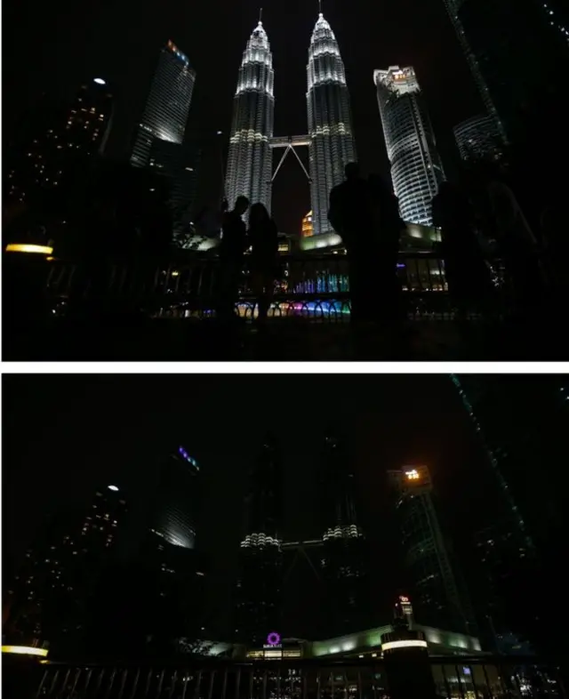 Kuala Lumpur's Petronas Towers momentarily disappeared into the night in Malaysia