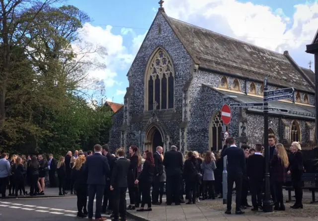 Mourners outside the church