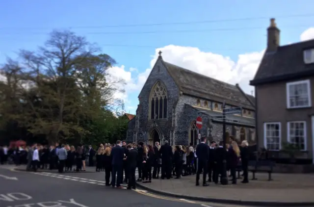 Mourners outside the church