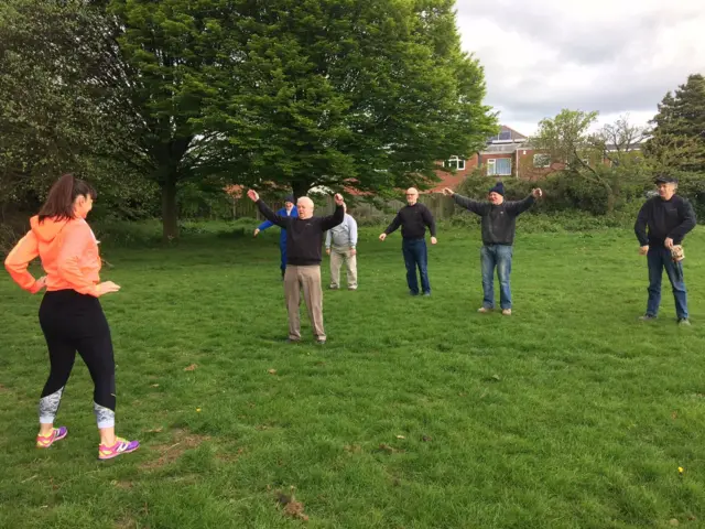 Men doing Zumba with an instructor