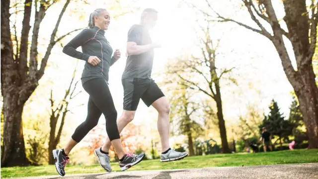 Two older people running