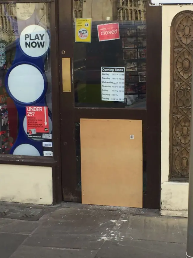 Broken door at newsagents