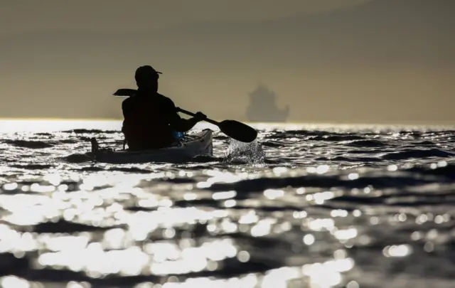 A South African man paddles a sea kayak in the Atlantic Ocean off Cape Town, South Africa 25 April 2017.