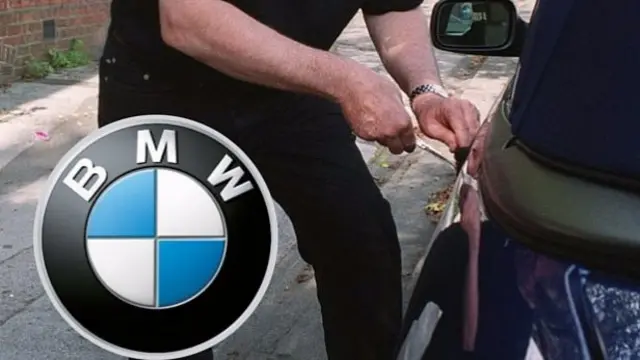 BMW sign, inset, and man trying to rob car