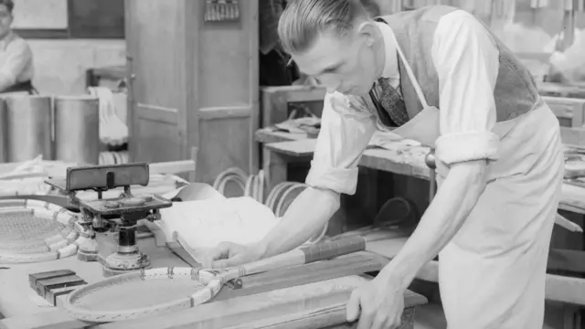 A worker at Dunlop's factory in Waltham Abbey in Essex was photographed checking the dimensions of a racket