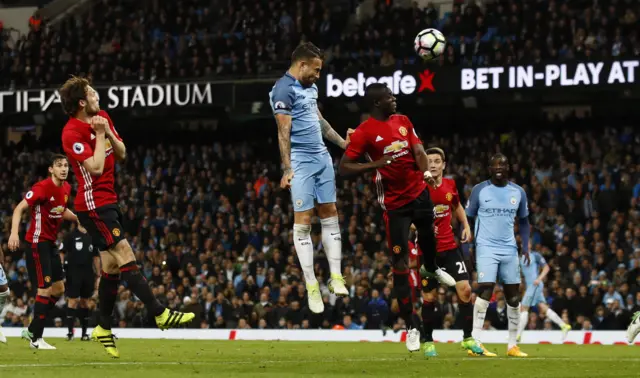 Manchester City's Otamendi heads over