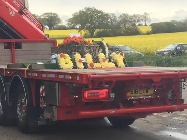 Flowers and coffin on HGV